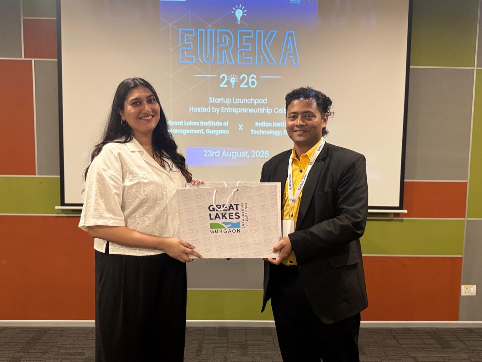 Dr Swapnil Sahoo presenting a Great Lakes Gurgaon memento to a guest in front of the EUREKA 2026 title screen