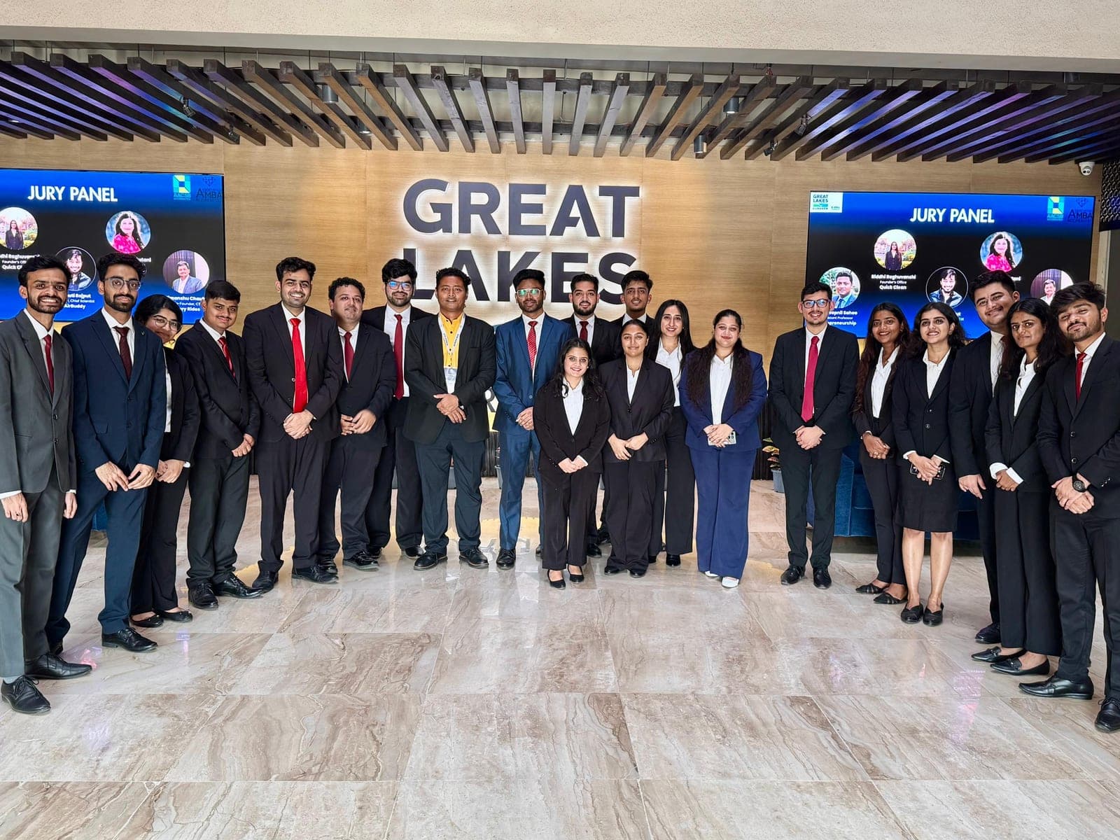 A second group photo of the EUREKA 2026 organizing team with the jury panel displayed on screens